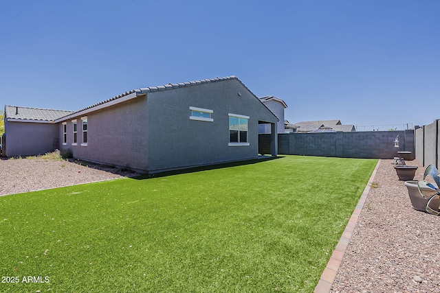 rear view of property with stucco siding and a tiled roof