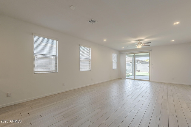spare room with a ceiling fan, baseboards, light wood-style flooring, and recessed lighting
