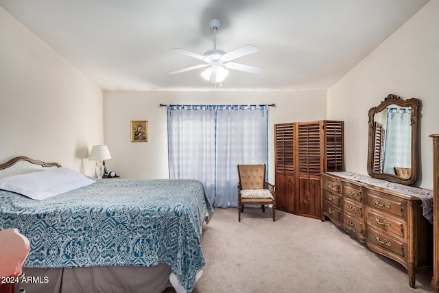 bedroom featuring light carpet and ceiling fan