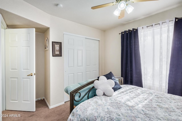 carpeted bedroom with a closet and ceiling fan