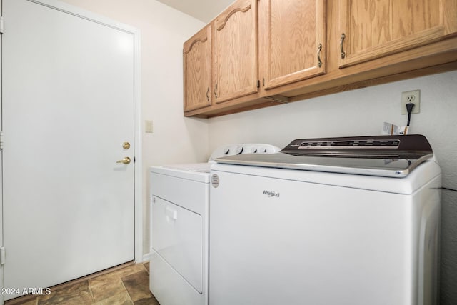 laundry area featuring cabinets and washer and clothes dryer