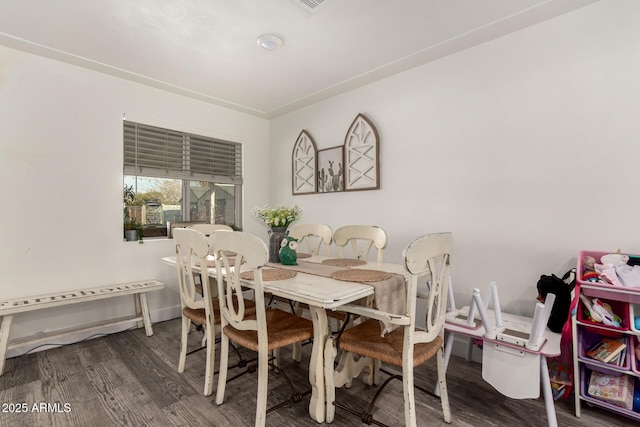 dining space with dark hardwood / wood-style floors