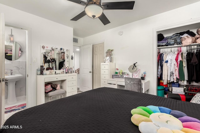 bedroom with sink, ceiling fan, and a closet