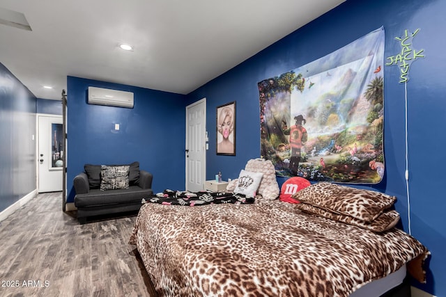 bedroom with wood-type flooring and an AC wall unit