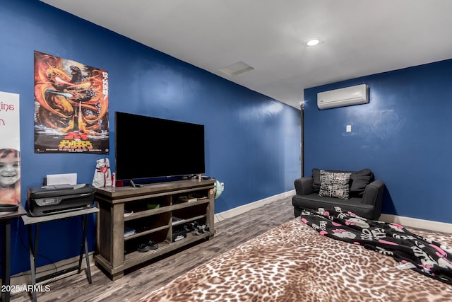 living room with hardwood / wood-style flooring and a wall mounted air conditioner