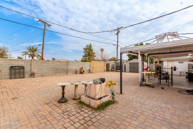 view of patio featuring a storage unit