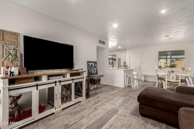 living room with plenty of natural light and light wood-type flooring