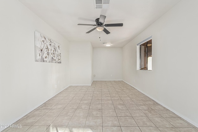 spare room featuring ceiling fan and light tile patterned floors