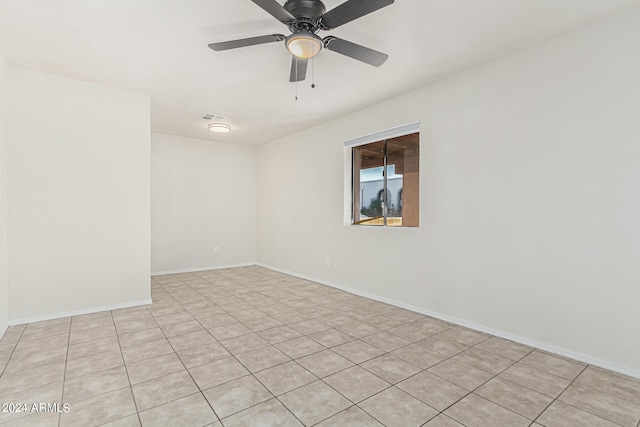 empty room with light tile patterned floors and ceiling fan