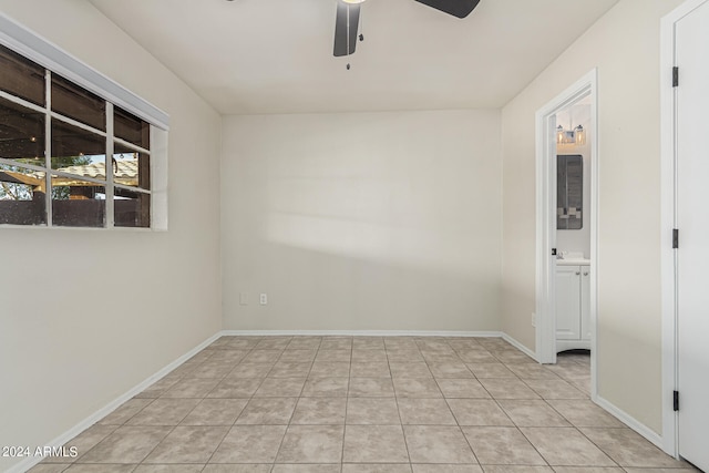 unfurnished room with light tile patterned flooring and ceiling fan