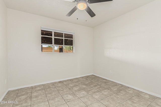 tiled spare room with ceiling fan