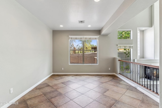tiled empty room with recessed lighting, baseboards, and visible vents