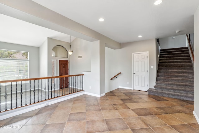 empty room with baseboards, visible vents, stairs, and recessed lighting