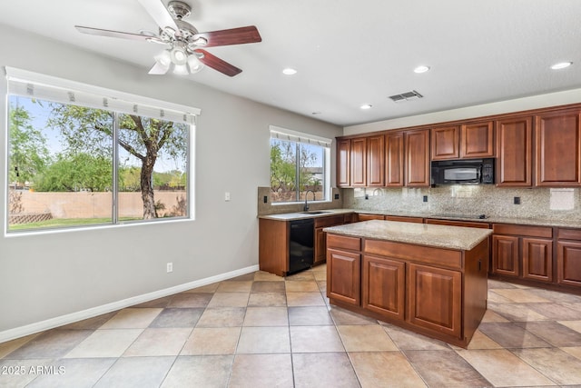 kitchen with tasteful backsplash, a center island, a sink, visible vents, and black appliances