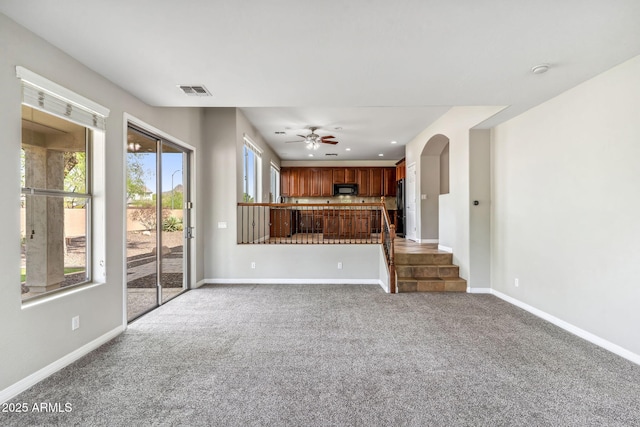 unfurnished living room featuring visible vents, baseboards, recessed lighting, a ceiling fan, and carpet floors