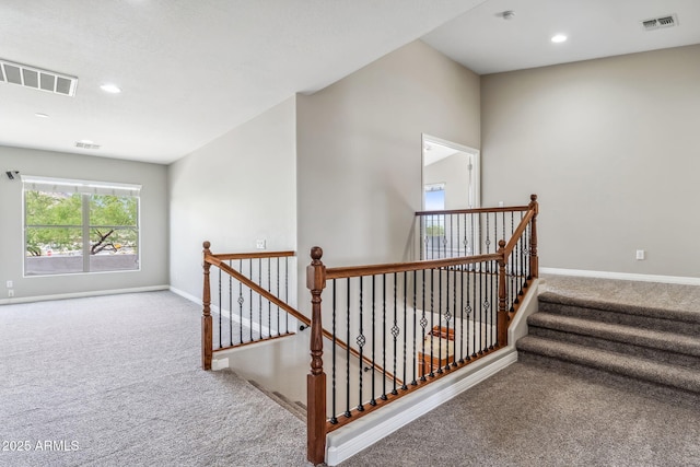 stairway with baseboards, carpet flooring, and visible vents
