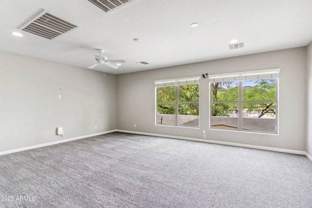 carpeted spare room with plenty of natural light and visible vents