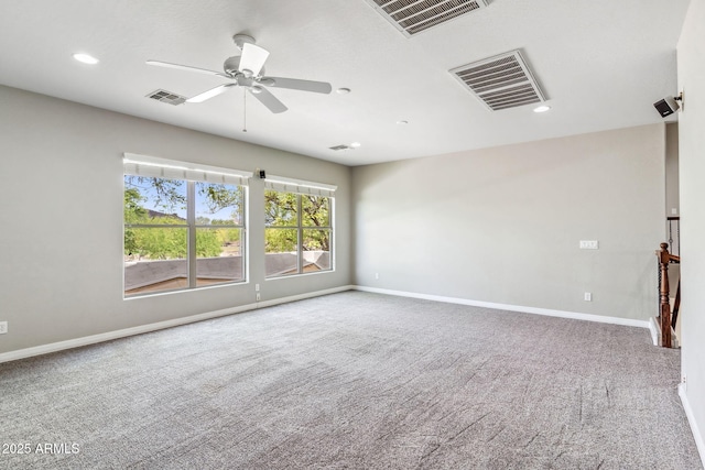 empty room with carpet, baseboards, and visible vents