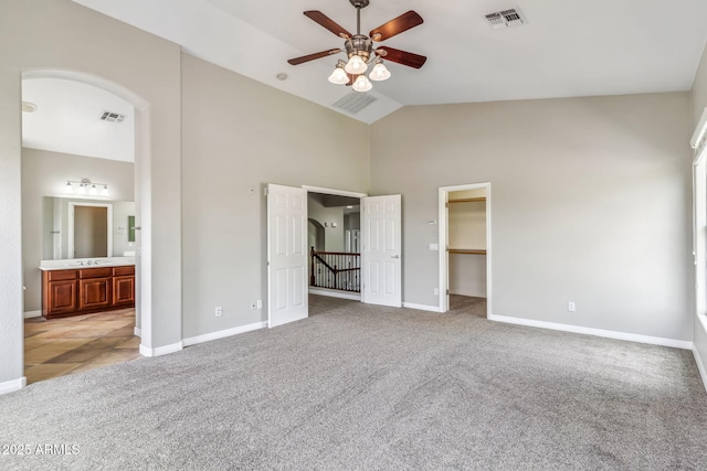 unfurnished bedroom with light colored carpet, visible vents, and a spacious closet
