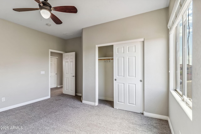 unfurnished bedroom featuring baseboards, carpet floors, ceiling fan, and a closet
