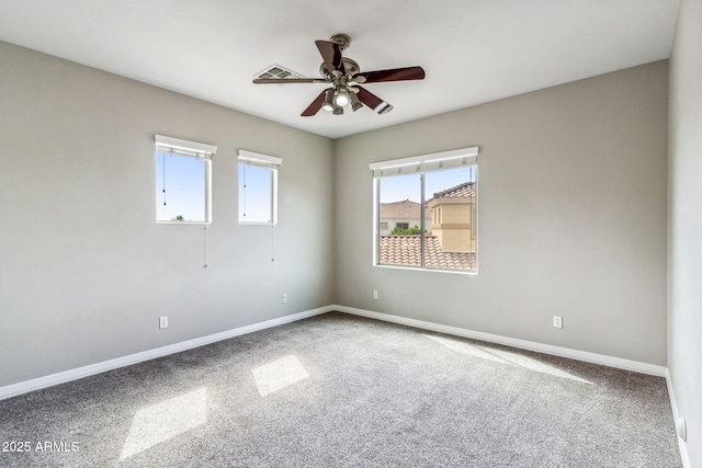 unfurnished room featuring baseboards, ceiling fan, and carpet