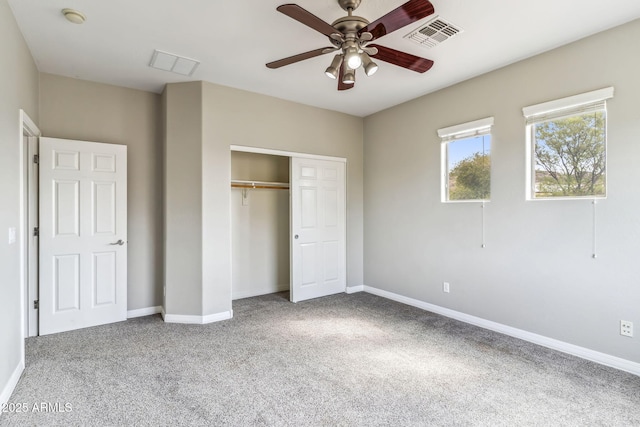unfurnished bedroom featuring baseboards, visible vents, a closet, and carpet