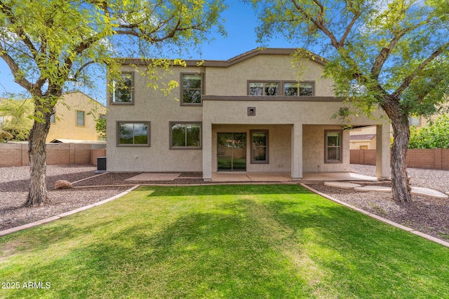 back of house featuring a patio area, central air condition unit, stucco siding, a fenced backyard, and a yard