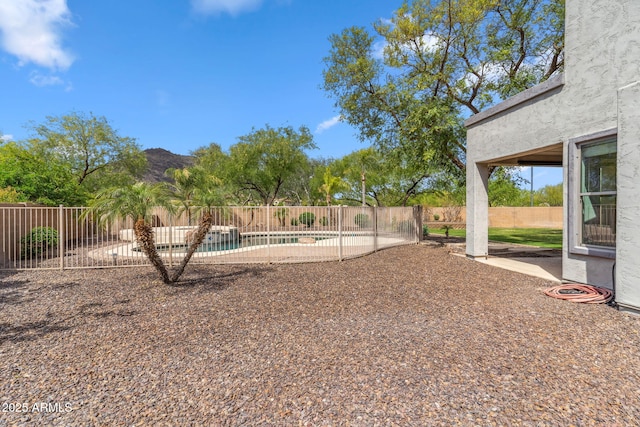 view of yard featuring fence, a fenced in pool, and a patio area