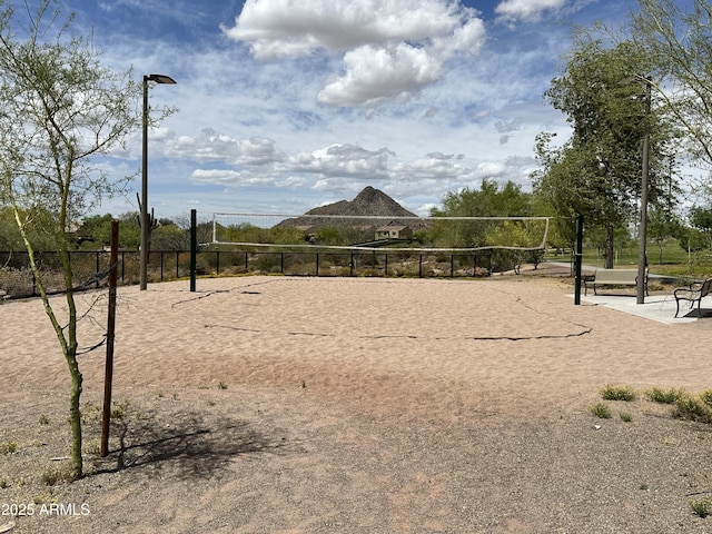 view of home's community with fence and volleyball court