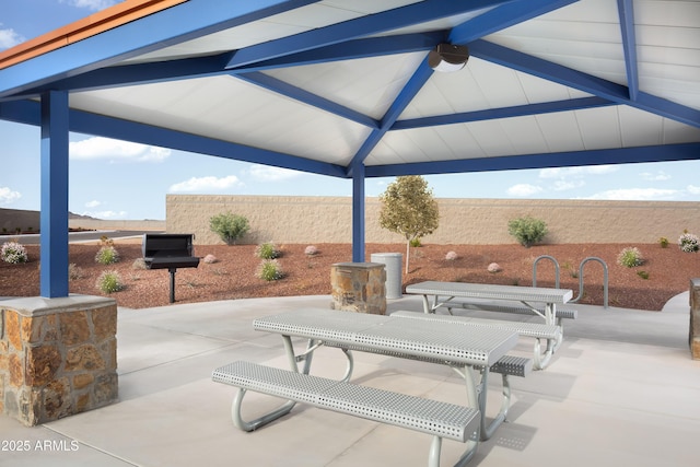 view of patio featuring a gazebo, fence, and ceiling fan