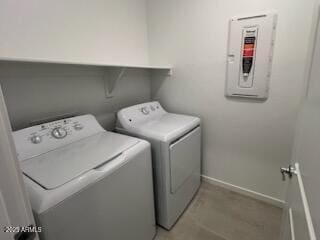 laundry area with independent washer and dryer, baseboards, and electric panel