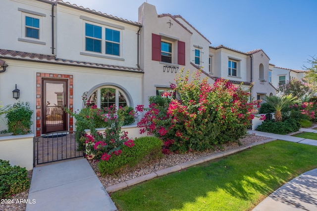 mediterranean / spanish-style house featuring a front lawn