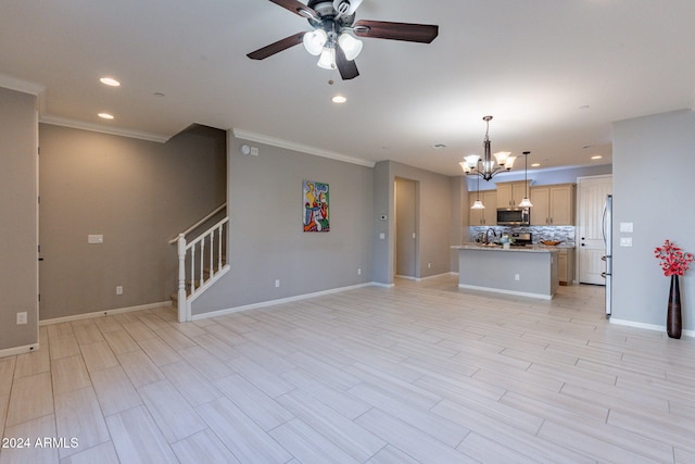 unfurnished living room featuring crown molding, ceiling fan with notable chandelier, and light hardwood / wood-style floors