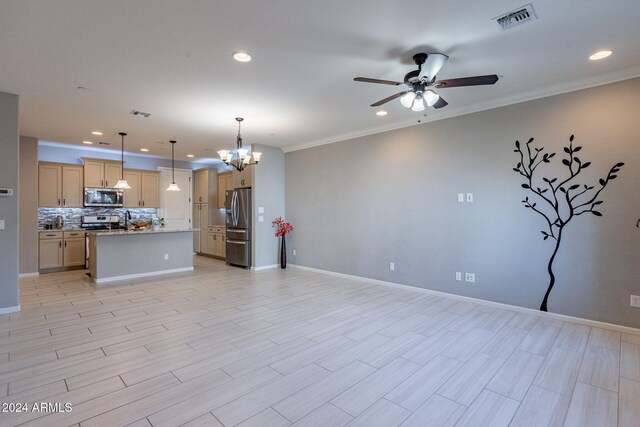 kitchen featuring a kitchen island with sink, light hardwood / wood-style flooring, stainless steel appliances, ornamental molding, and decorative light fixtures