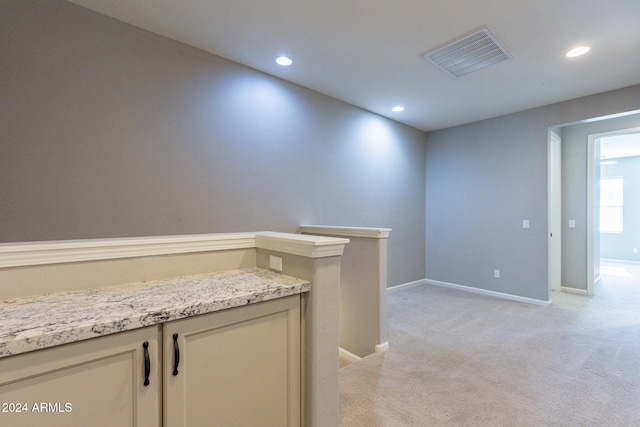 hallway with light colored carpet