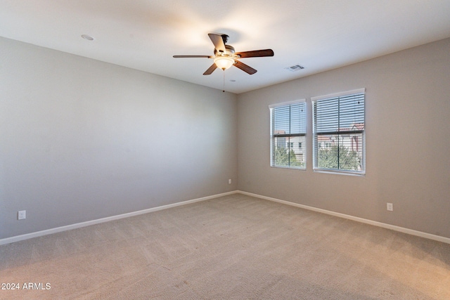 empty room featuring carpet flooring and ceiling fan