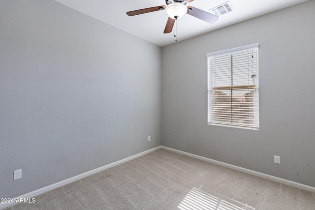 unfurnished room featuring light carpet and ceiling fan