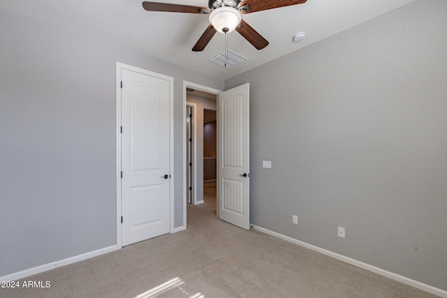 unfurnished bedroom featuring ceiling fan and light colored carpet