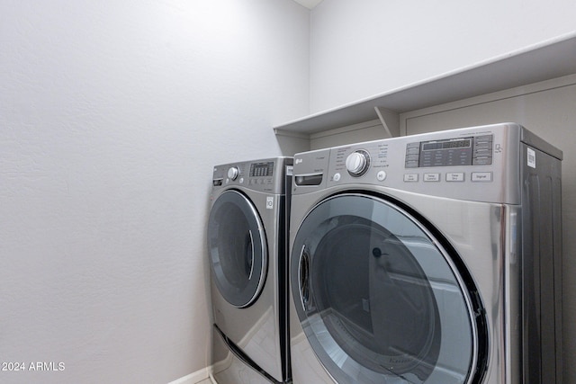 washroom with washer and dryer