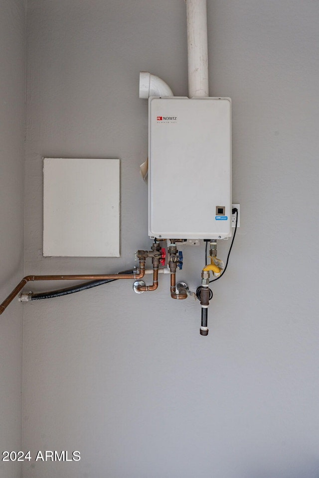 utility room featuring tankless water heater