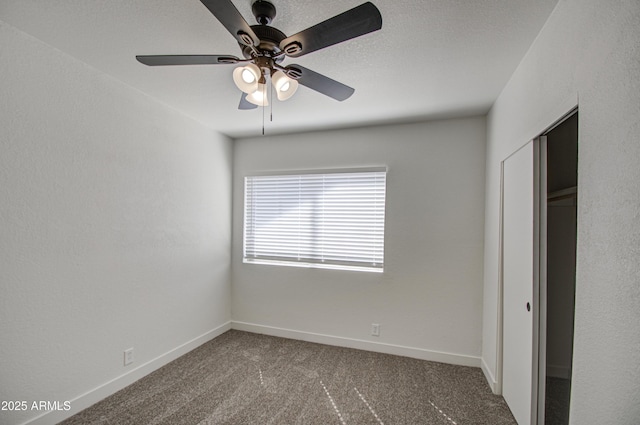 unfurnished bedroom featuring a ceiling fan, baseboards, carpet, and a closet