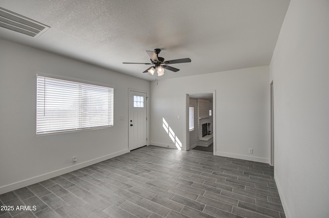 entrance foyer with baseboards, visible vents, ceiling fan, and dark wood-style flooring