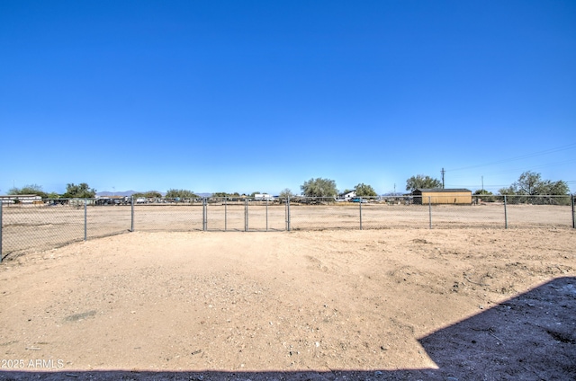 view of yard featuring fence and a rural view