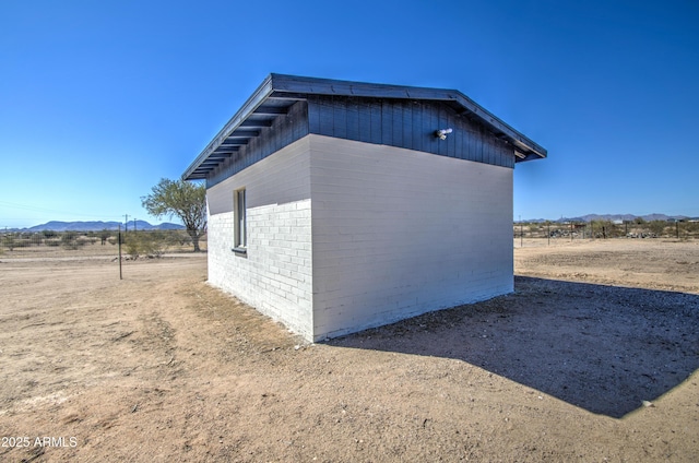 view of side of home with a mountain view