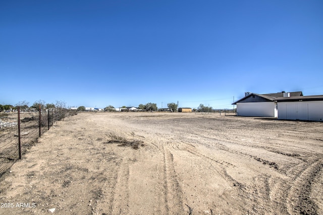 exterior space with a rural view and fence
