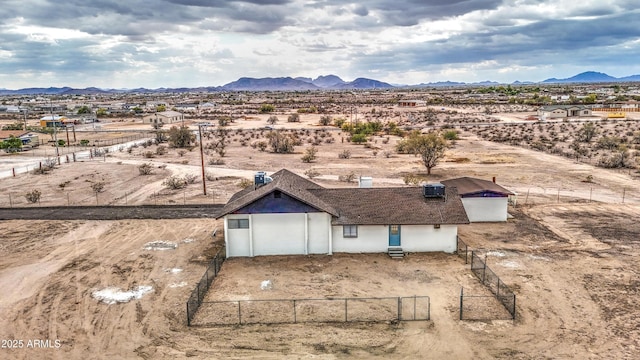 drone / aerial view featuring a mountain view, a desert view, and a rural view