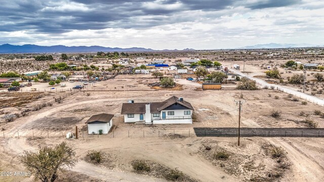 birds eye view of property with view of desert, a rural view, and a mountain view