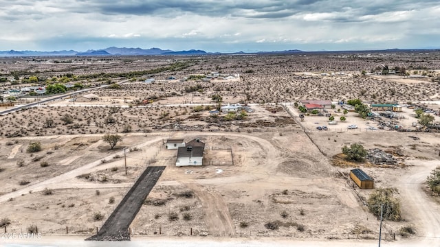 drone / aerial view with a mountain view, a rural view, and view of desert