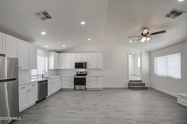 kitchen with visible vents, appliances with stainless steel finishes, a ceiling fan, and a sink