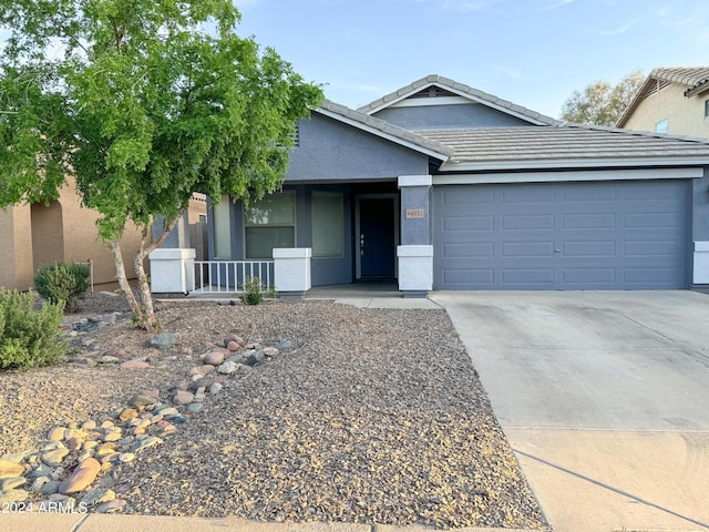 view of front of home with a porch and a garage